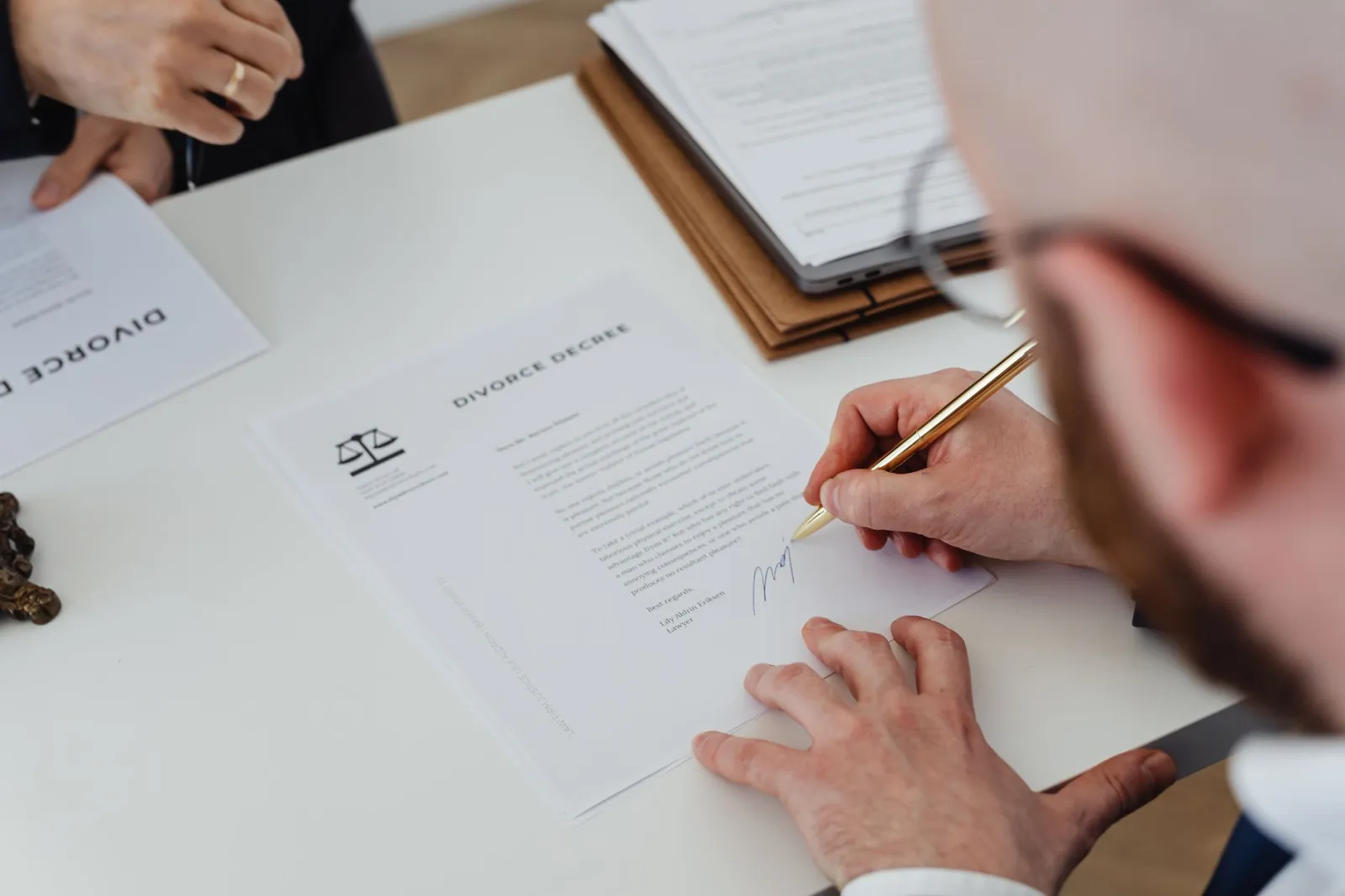 Signing documents at a real estate closing table